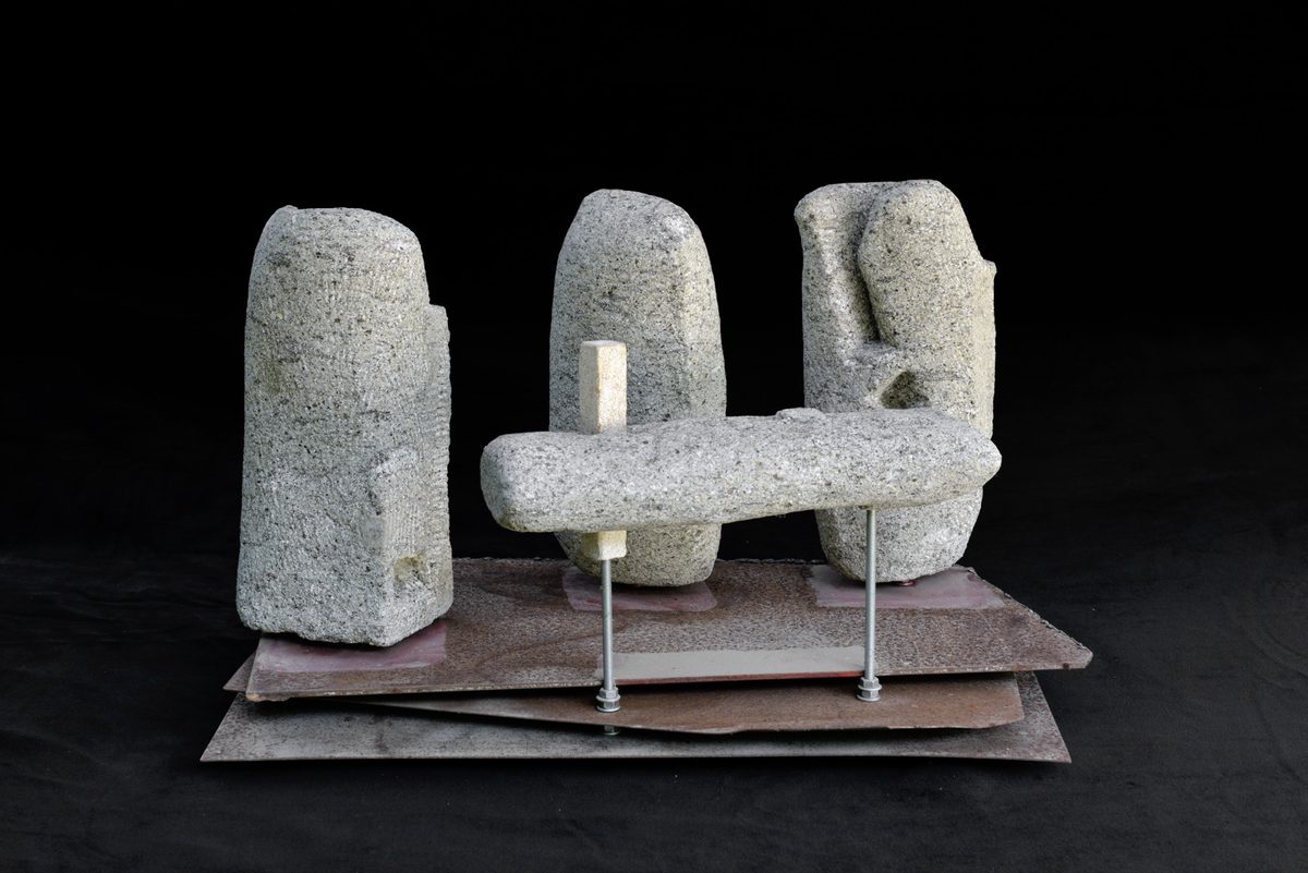 Peperino su tre ferri — three peperino monoliths joined by an iron bar on a base of rusted iron sheets, sculpture by Paul Klerr